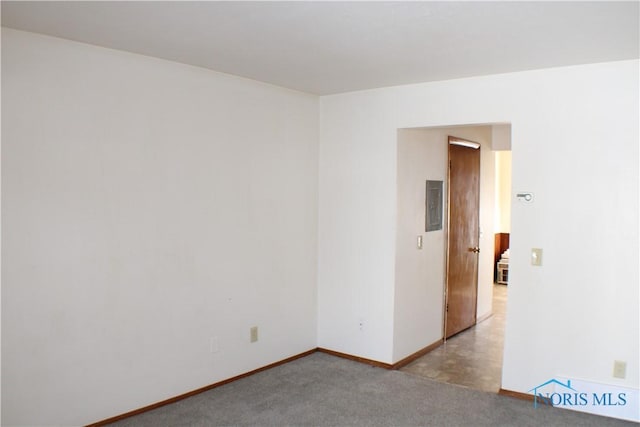 carpeted empty room with electric panel