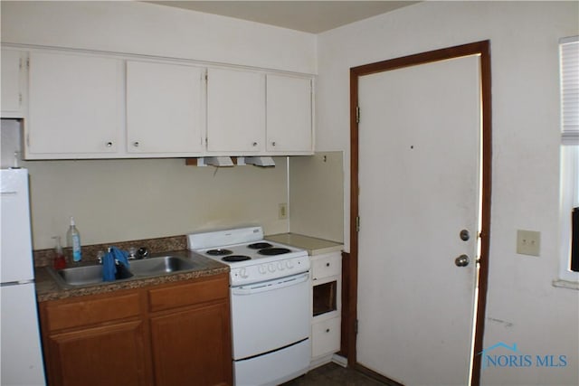 kitchen with white cabinetry, sink, and white appliances