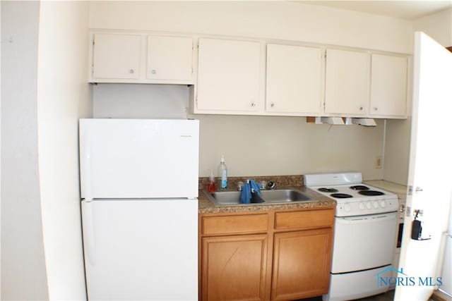 kitchen featuring white appliances, sink, and white cabinets