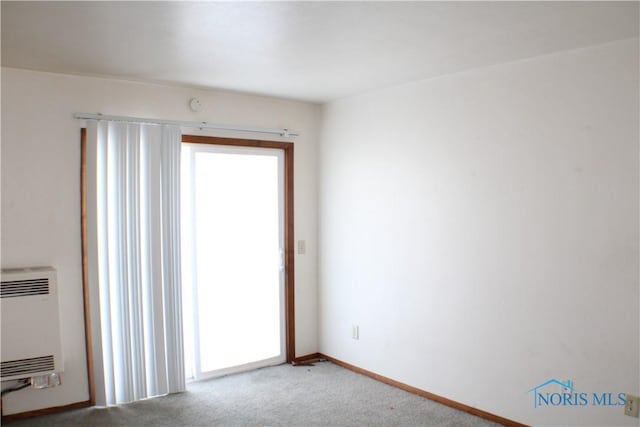 empty room with carpet flooring and heating unit