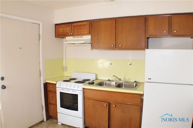 kitchen featuring white appliances and sink