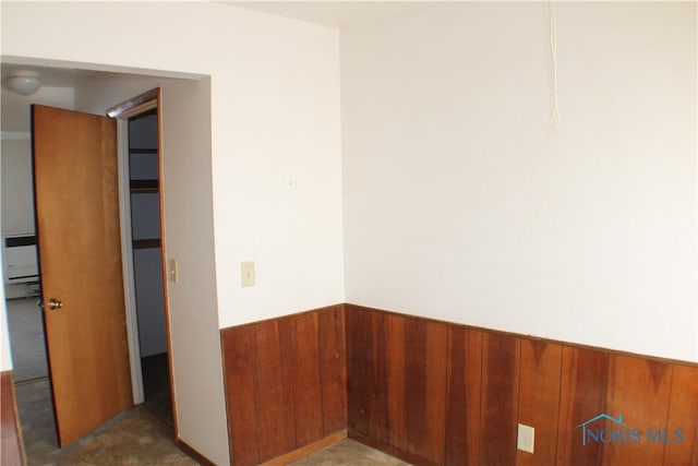 empty room featuring wooden walls