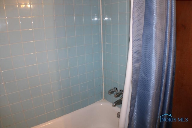 bathroom featuring shower / bath combination with curtain