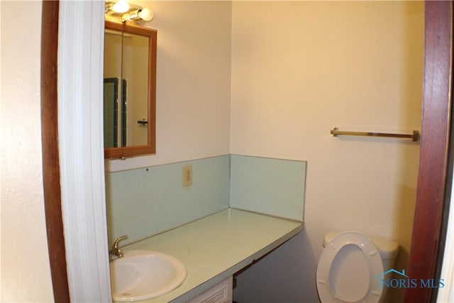 bathroom featuring vanity and toilet