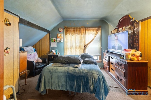 bedroom featuring lofted ceiling, light carpet, and a textured ceiling