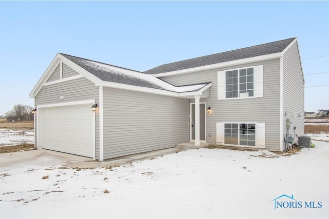 exterior space with a garage and central air condition unit