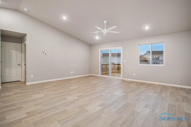 empty room featuring ceiling fan, lofted ceiling, and light wood-type flooring