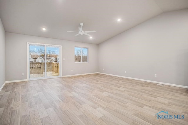 spare room featuring light hardwood / wood-style flooring, ceiling fan, and vaulted ceiling