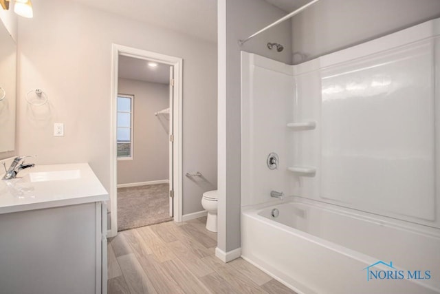 full bathroom with hardwood / wood-style flooring, vanity, toilet, and bathing tub / shower combination