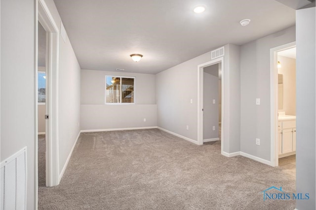 unfurnished room featuring light carpet