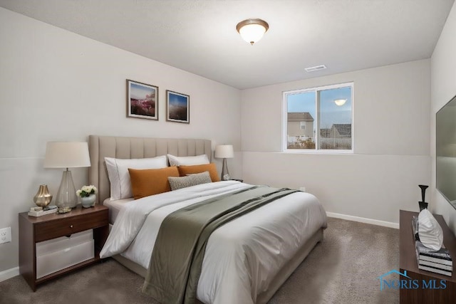 bedroom featuring dark carpet