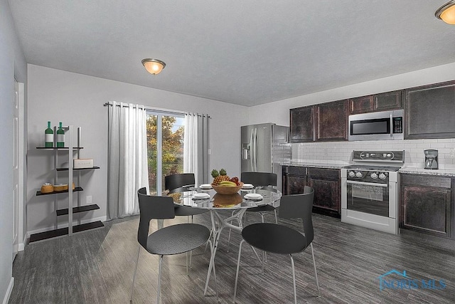 dining space featuring baseboards and dark wood-type flooring