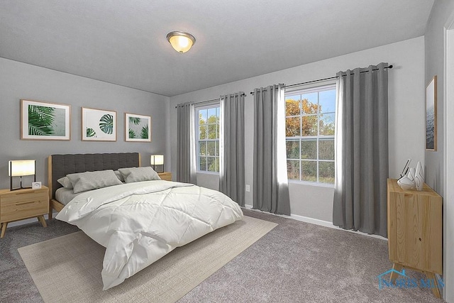 carpeted bedroom featuring baseboards