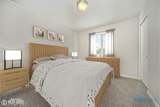 bedroom with baseboards and light carpet