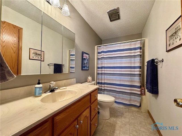 bathroom with walk in shower, vanity, toilet, and a textured ceiling