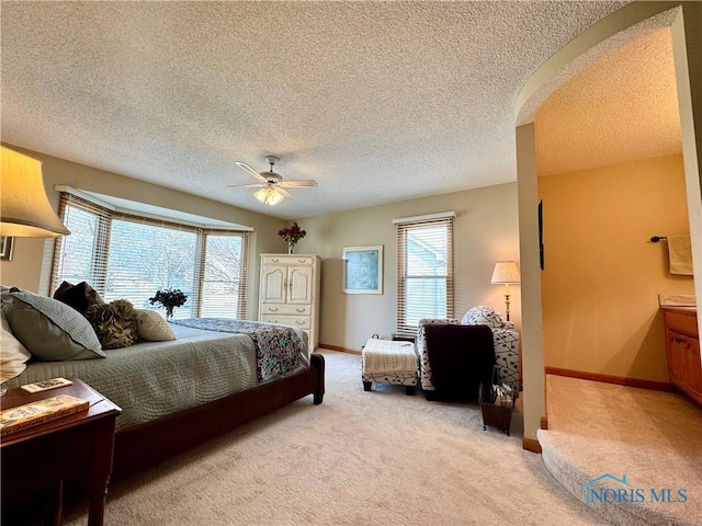 carpeted bedroom featuring multiple windows and ceiling fan