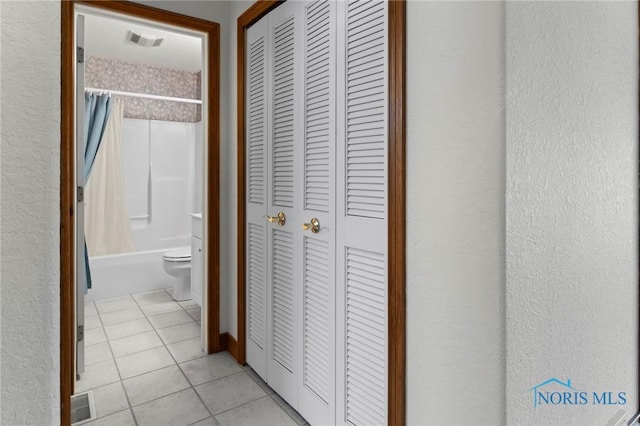 hallway featuring light tile patterned flooring