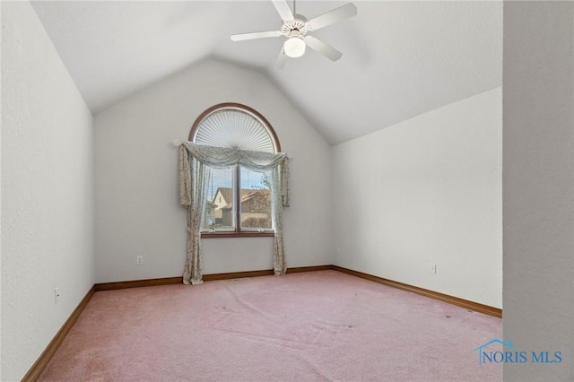 carpeted empty room with ceiling fan and vaulted ceiling