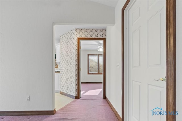 hall with light colored carpet