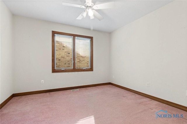 unfurnished room with light colored carpet and ceiling fan