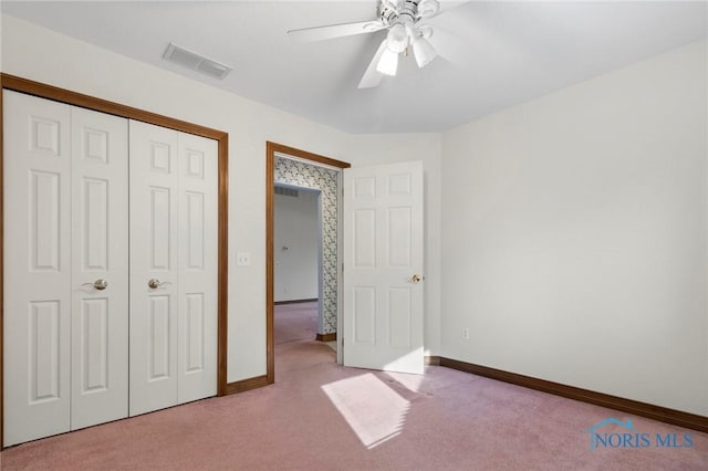 unfurnished bedroom with ceiling fan, a closet, and light carpet