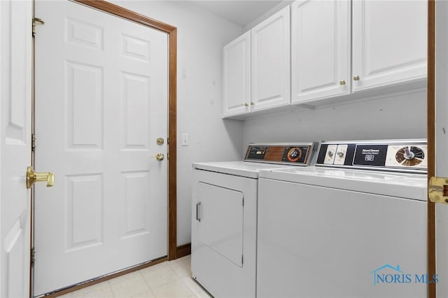 laundry room featuring cabinets and separate washer and dryer