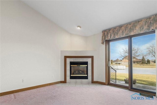 unfurnished living room featuring a water view, light colored carpet, and a fireplace