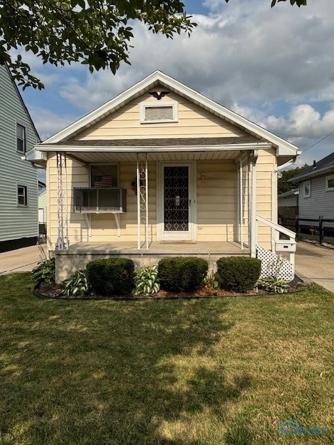 bungalow with a front lawn and a porch