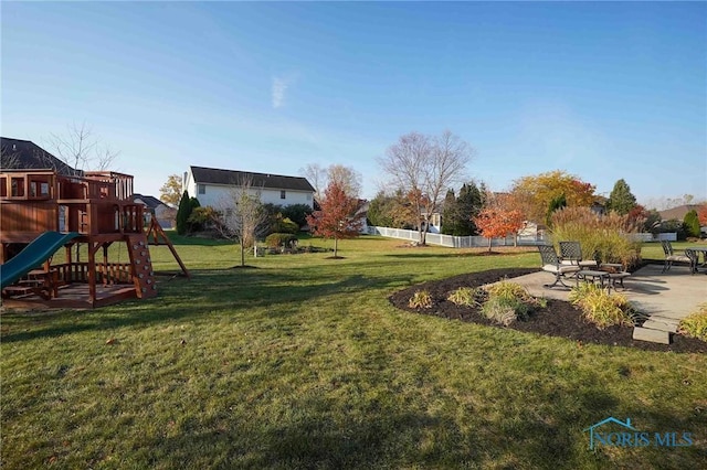 exterior space featuring a playground, a lawn, and a patio area