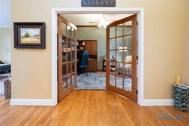 office with french doors and light wood-type flooring