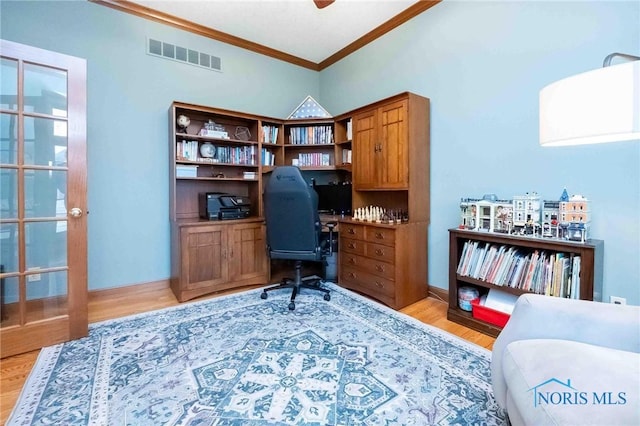 office space with crown molding and light hardwood / wood-style flooring