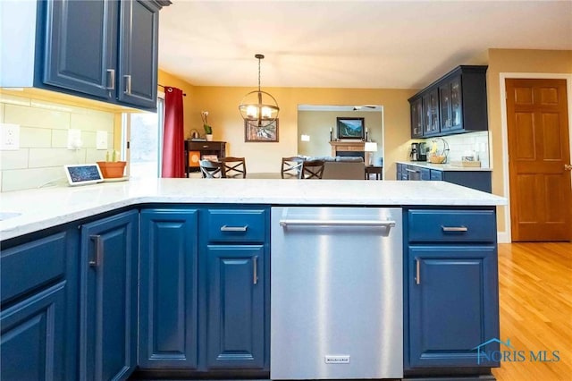 kitchen featuring blue cabinets, light wood-type flooring, kitchen peninsula, dishwasher, and pendant lighting