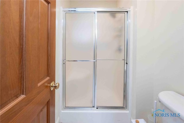 bathroom featuring toilet and walk in shower