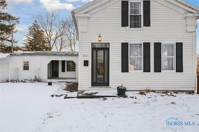 snow covered house with a garage