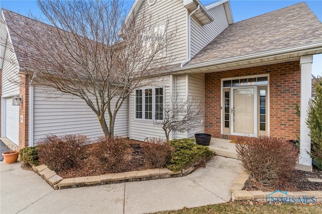 view of exterior entry with a garage