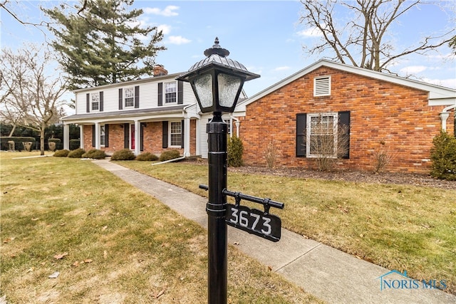 view of front of home with a front yard and covered porch