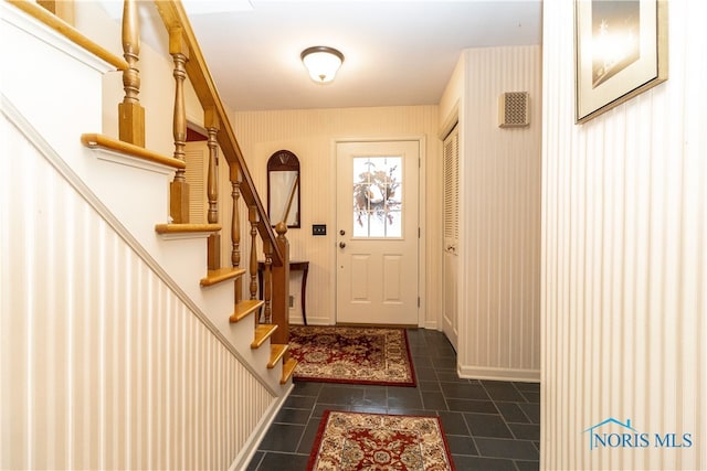 doorway featuring dark tile patterned floors