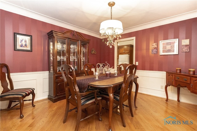 dining space featuring an inviting chandelier and light wood-type flooring