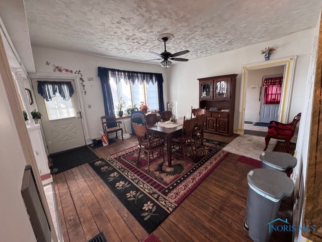 dining space featuring ceiling fan, dark hardwood / wood-style floors, and a textured ceiling