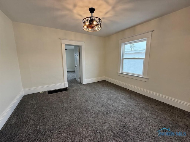 empty room with dark colored carpet