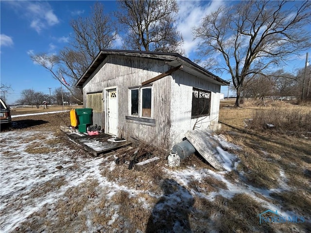 view of snow covered exterior featuring an outdoor structure