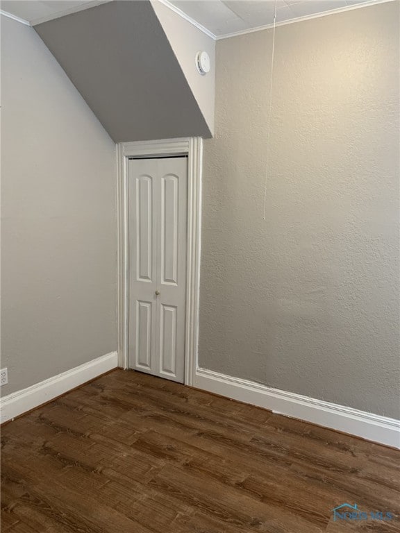 unfurnished room with ornamental molding and dark hardwood / wood-style floors