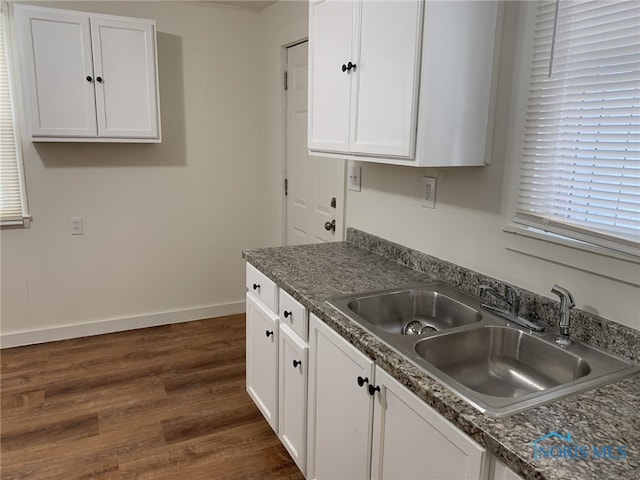 kitchen featuring sink, dark wood-type flooring, and white cabinets