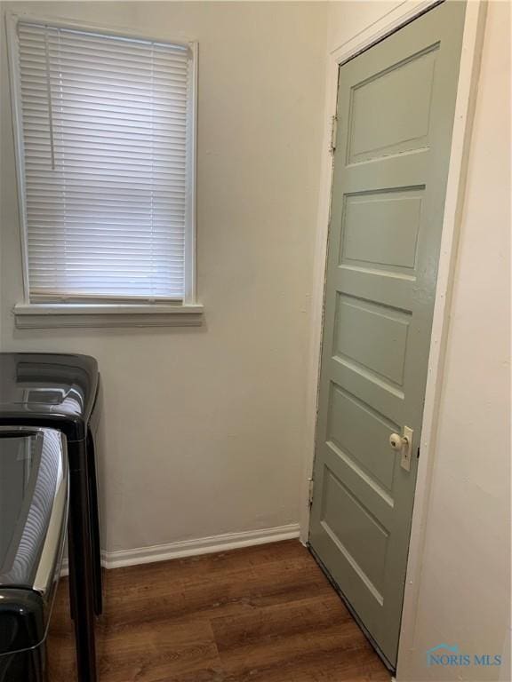 laundry area featuring dark wood-type flooring