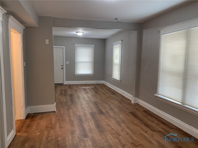 spare room with dark hardwood / wood-style flooring