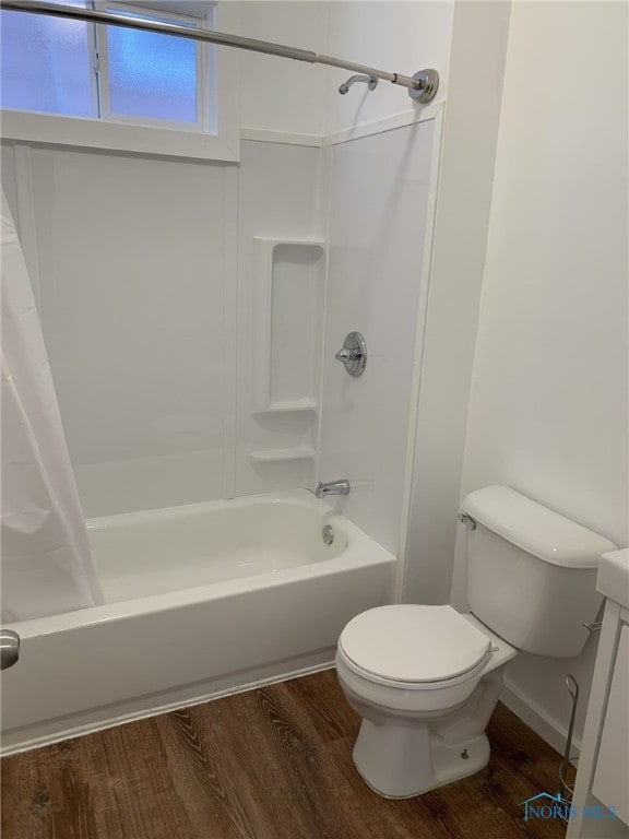 bathroom with shower / tub combo, hardwood / wood-style floors, and toilet