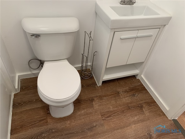 bathroom with vanity, hardwood / wood-style floors, and toilet