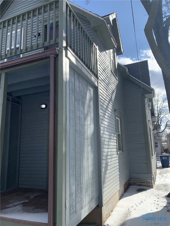 view of side of home featuring a balcony