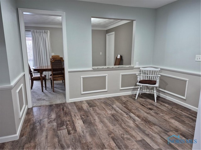 unfurnished dining area with ornamental molding and dark hardwood / wood-style floors