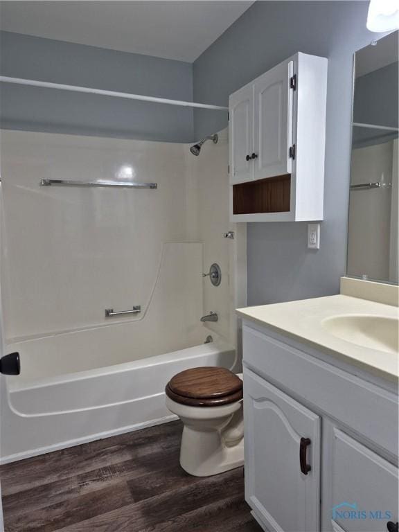 full bathroom with vanity, tub / shower combination, hardwood / wood-style floors, and toilet